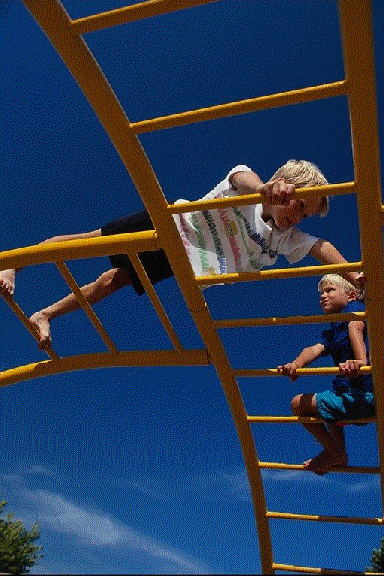 Two Children on a ladder at the playground.